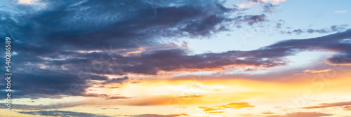 Small clouds at a beautiful sunset panorama