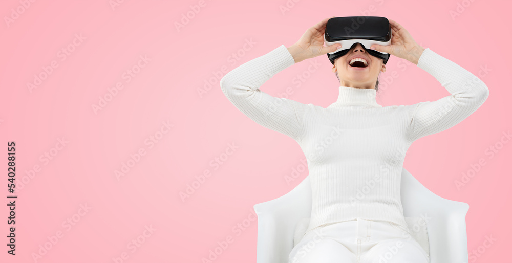 Horizontal banner of female feeling excited with her virtual reality experience, holding VR headset