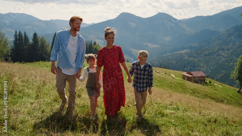 Fotografie Carefree family stroll mountain slope summer holiday
