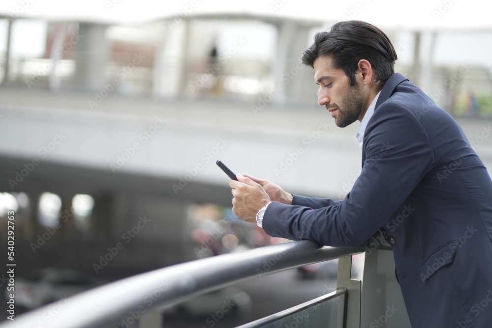 businessman using smartphone in city street. businessman using smartphone in city street.