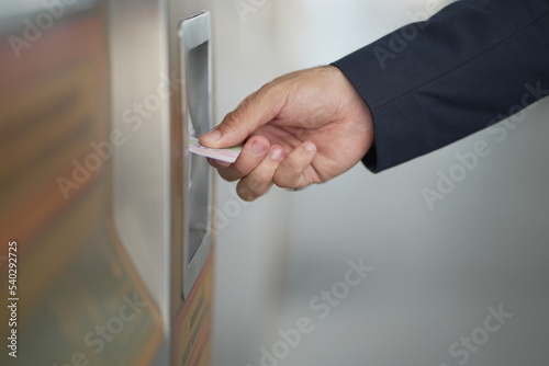 Businessman buying ticket on train station. Asking for price. businessman buying a ticket in a machine on subway station.
