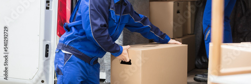 Side View Of A Man Carrying Cardboard Box