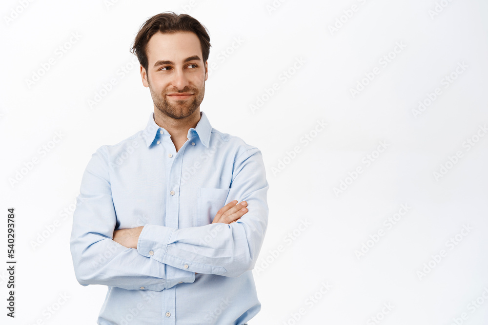 Handsome businessman standing in power pose, cross arms on chest, looking confident and professional, standing over white background Handsome businessman standing in power pose, cross arms on chest, looking confident and professional, standing over white background
