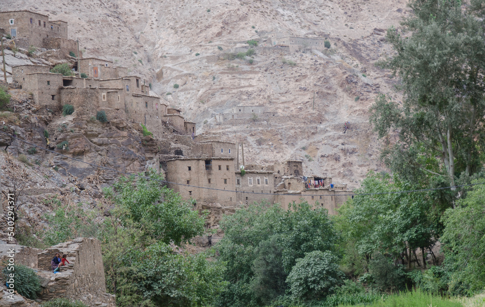 ancient village, castle on hills, in the Moroccan mountains, beautiful nature, large valleys, historical ruins, sublime architecture built by natural means, stone and sand.