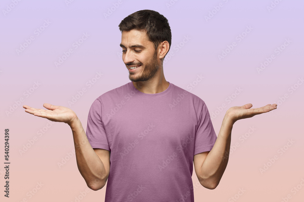 Man choosing between 2 different options, holding two hands with empty space on purple background