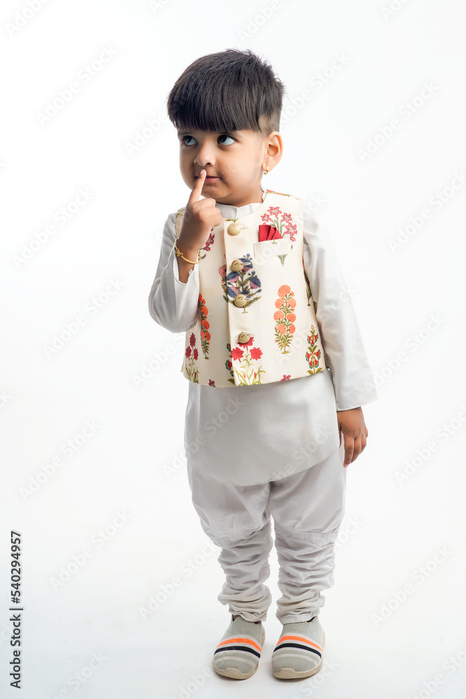 Cute indian little child in ethnic wear and showing expression over white background Cute indian little child in ethnic wear and showing expression over white background