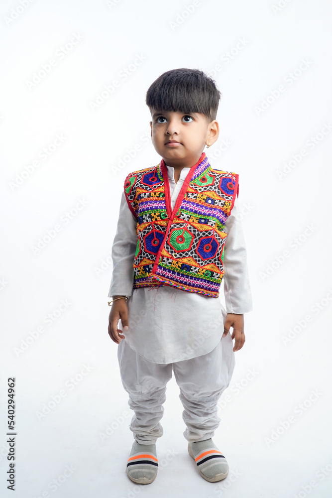 Cute indian little child in ethnic wear and showing expression over white background Cute indian little child in ethnic wear and showing expression over white background