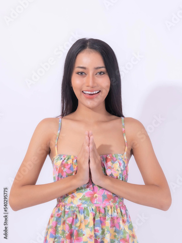 Portrait beautiful Asian young woman , thai woman , showing gesture hand pay respect sawasdee symbol from Thailand greeting culture for hello or goodbye isolated on white background with copy space photo