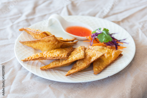 Thai food appetizer of fried wontons on plate