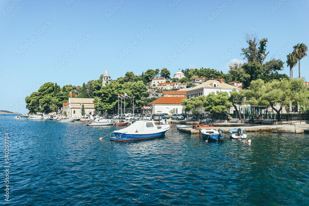 View of holiday small coast town with clear water, green trees and colorful houses