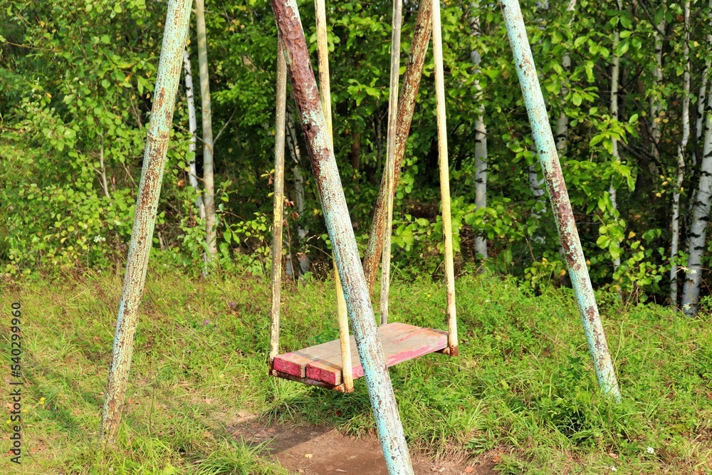 Fototapeta premium Old metal rusty swing in the park