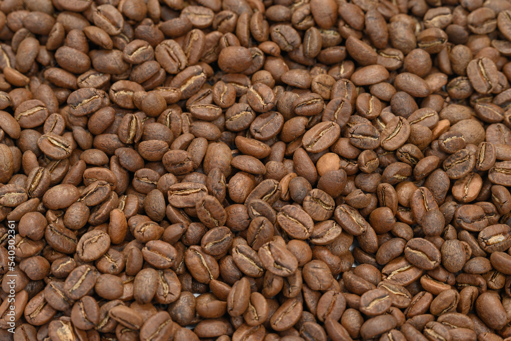 Fragrant and roasted coffee beans on a white background, place for inscription and advertising. Fragrant and roasted coffee beans on a white background, place for inscription and advertising.