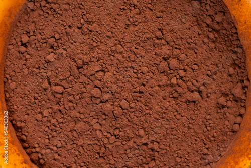 cocoa powder in a bowl shot on a macro lens, powder for making chocolate.