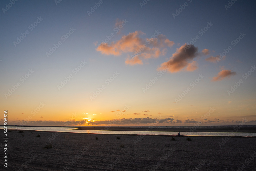 Sunset, birds, sun and clouds in Kijkduin, Den Haag, Netherlands. NL.