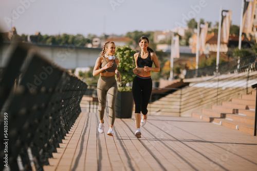 Young woman taking running exercise by the river promenade