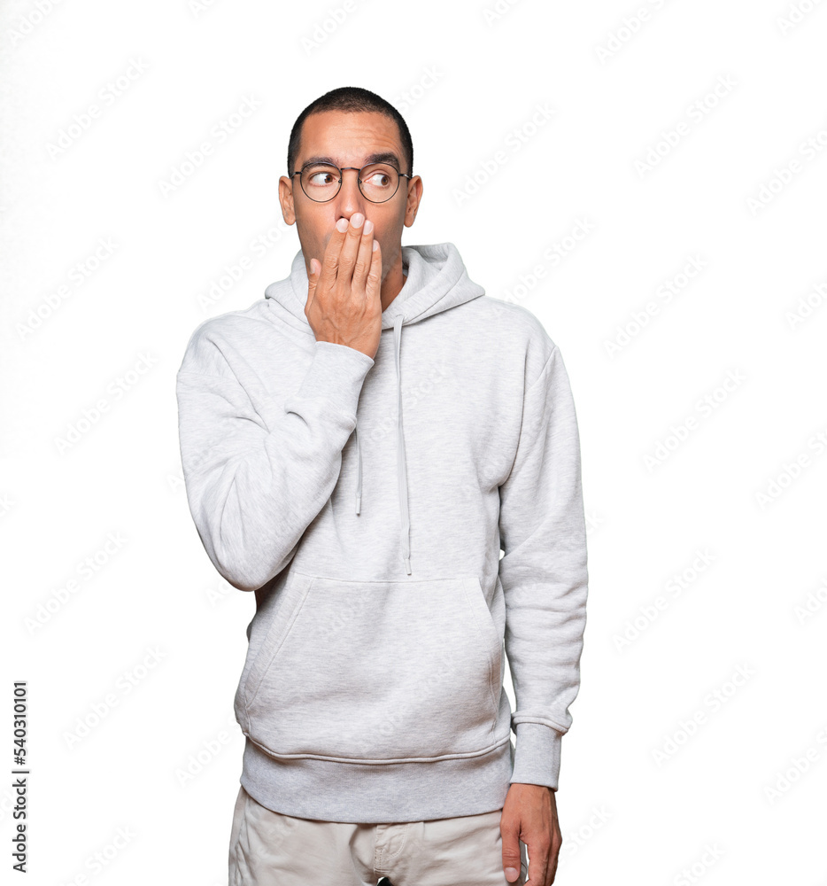 Astonished young man with a gesture of shock Astonished young man with a gesture of shock