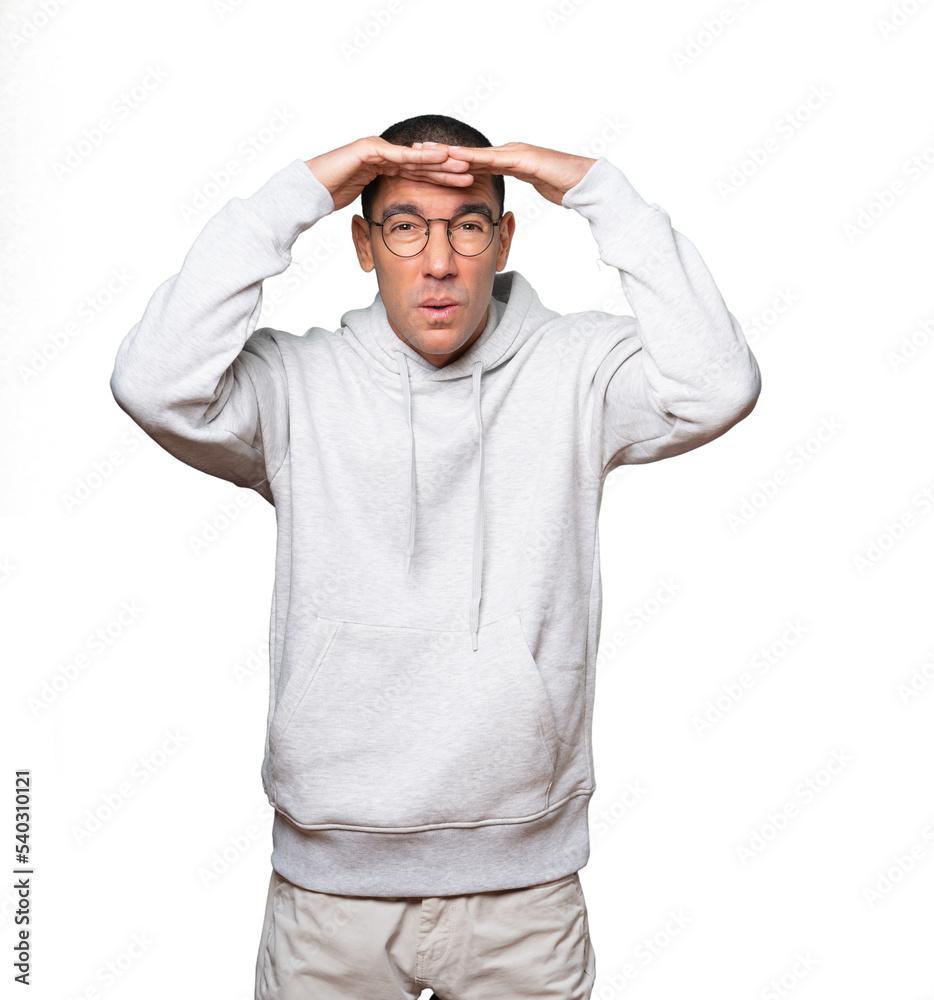 Concentrated young man with a gesture of looking far Concentrated young man with a gesture of looking far
