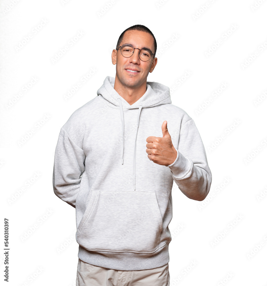 Happy young man gesturing that everything is fine Happy young man gesturing that everything is fine