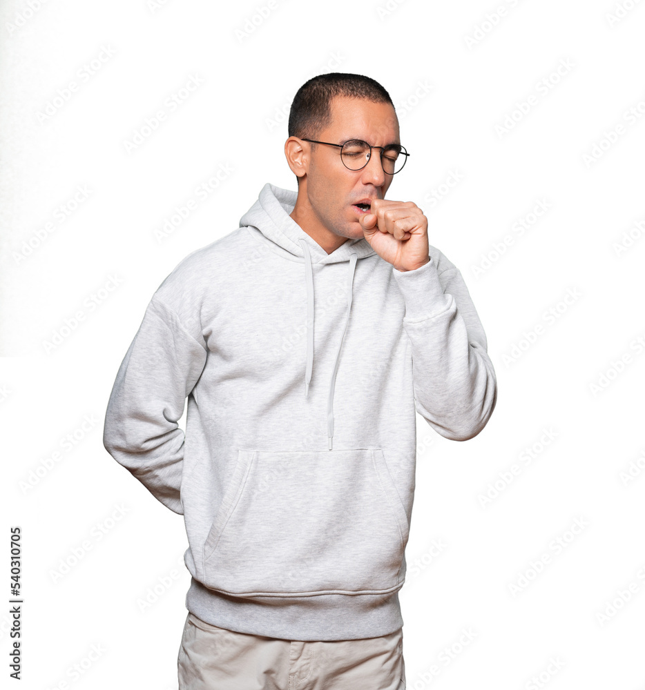 Sick young man coughing Sick young man coughing