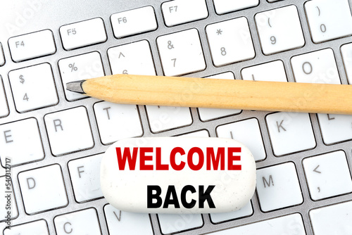WELCOME BACK text on eraser with pencil on keyboard