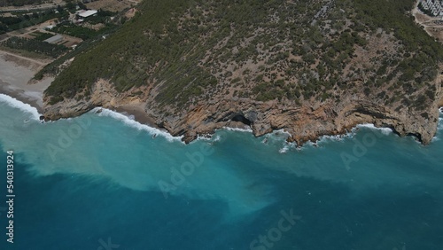 Aerial shot of a rocky hill in Yanisli Cave Beach, Gulnar, Mersin, Turkey photo