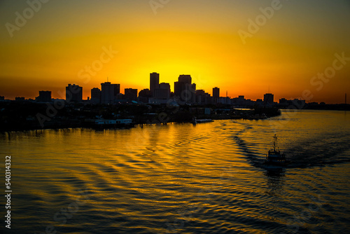 Aerial Orange Skyline of New Orleans at Dusk from Mississippi river