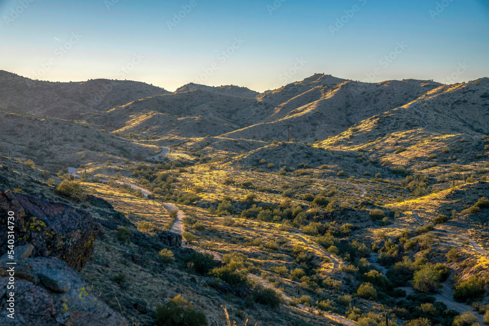 Phoenix, Arizona- Pima Canyon trail on a valley against the sunset skyline