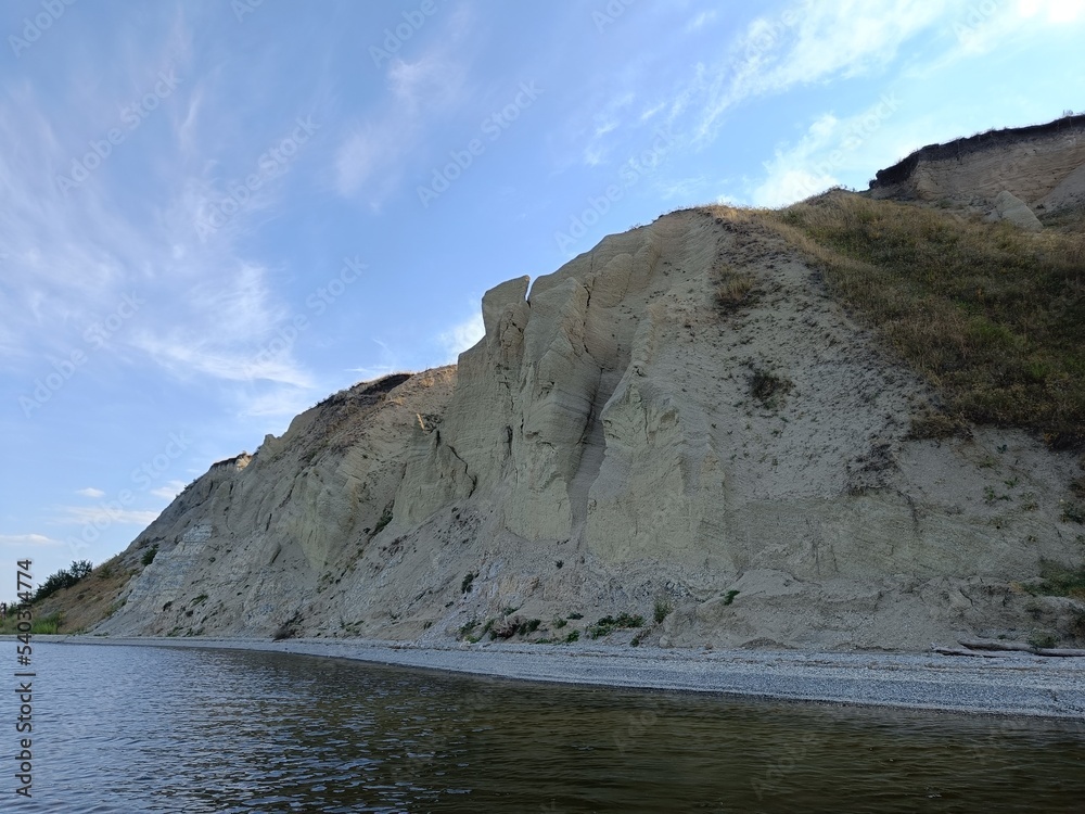 Summer landscape with a high, rocky and steep river Bank in Sunny weather. Russia, Saratov region, Volga river