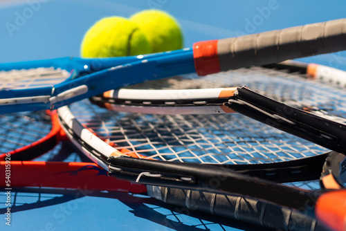 a broken tennis racket blue tennis court. photo