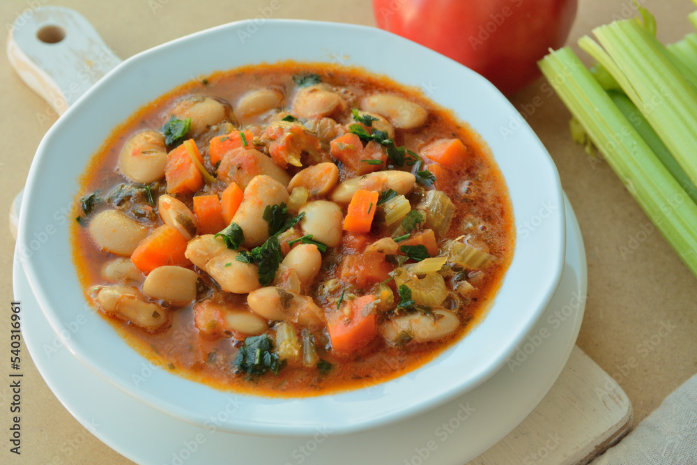 Traditional Greek soup of white beans, carrots and celery in a tomato sauce Traditional Greek soup of white beans, carrots and celery in a tomato sauce