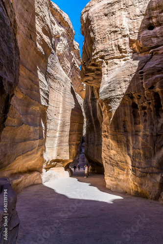 The path narrows as it approaches the ancient city of Petra, Jordan in summertime