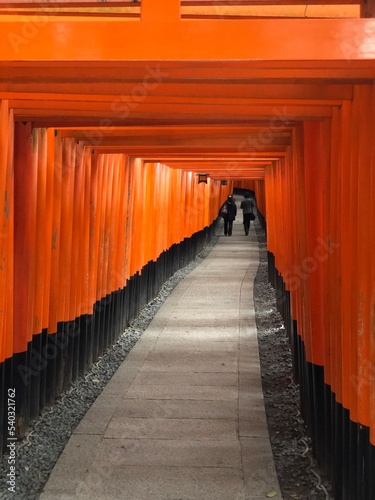 Two people walking in Fushimi Inari Shrine in Kyoto