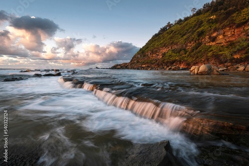 Beautiful shot of a flowing stream near Forresters Beach on NSW Central Coast in Australia photo