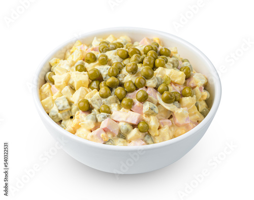 Olivier salad with vegetables, sausage and peas is isolated on a white background. Side view, close-up.