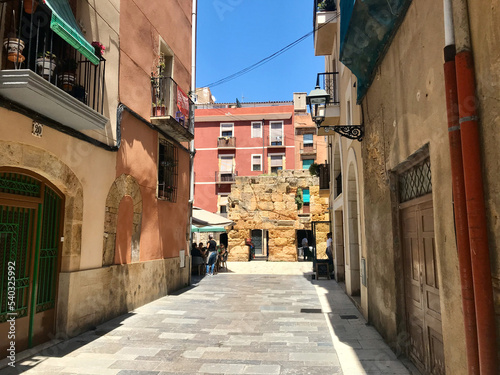 Tarragona  Spain  June 2019 - A narrow city street with buildings in the background