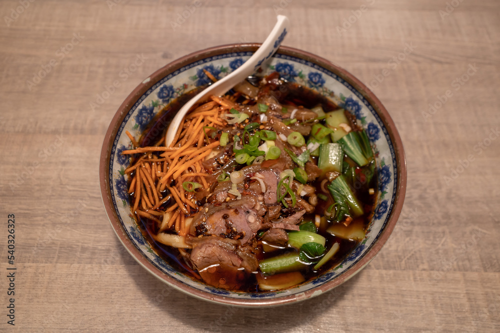 Chinese Spicy goulash Beef Noodle Soup on wooden counter table. Chinese Spicy goulash Beef Noodle Soup on wooden counter table.