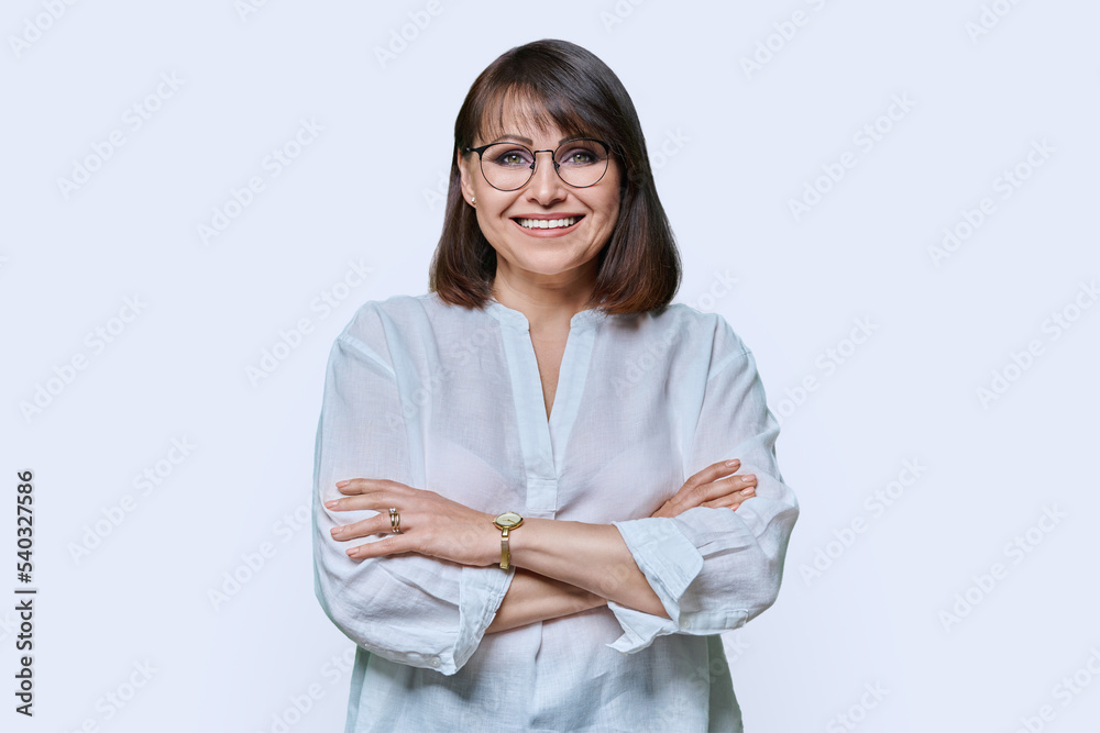 Attractive middle aged woman looking at camera on white background Attractive middle aged woman looking at camera on white background