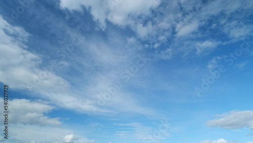 Blue sky with cumulus and cirrus on different layers clouds. Beautiful sky with clouds background. Timelapse.