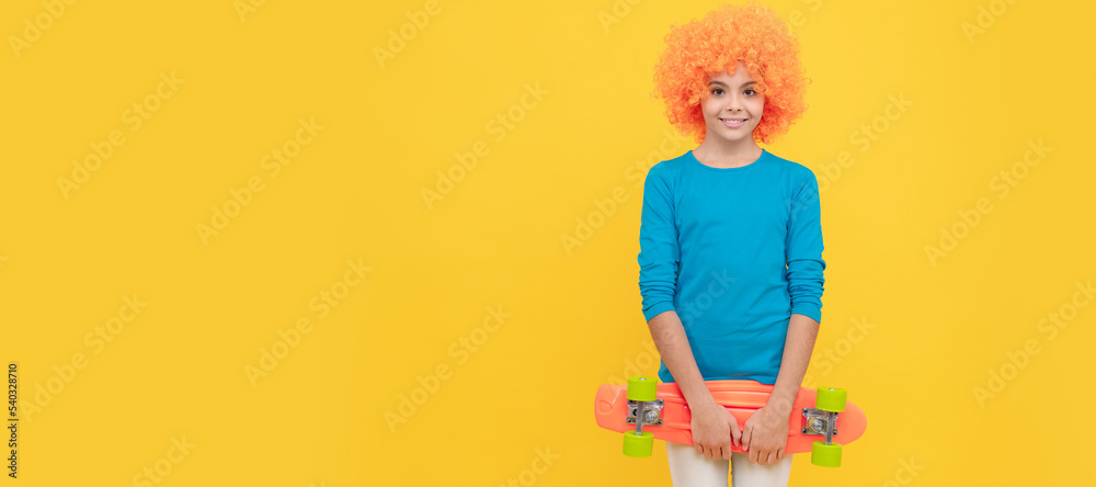 cheerful selfish child girl in curly wig hold penny board, copy space, childhood. Funny teenager child on party, poster banner header with copy space. cheerful selfish child girl in curly wig hold penny board, copy space, childhood. Funny teenager child on party, poster banner header with copy space.