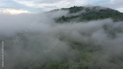 Mist rising through cloudforest in the foothills of  moution,Morning mist over the valley among the mountains in the sunlight. Fog and Beautiful nature of  aerial footage.