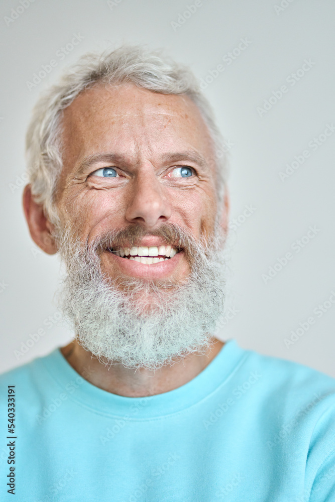 Smiling mature older gray-haired man, happy bearded old senior businessman looking away dreaming of good future, thinking of new vision standing isolated on white wall. Vertical close up Smiling mature older gray-haired man, happy bearded old senior businessman looking away dreaming of good future, thinking of new vision standing isolated on white wall. Vertical close up