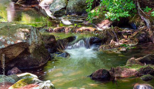 water cascading  in a small stream in new england photo