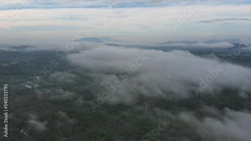 Mist rising through cloudforest in the foothills of  moution,Morning mist over the valley among the mountains in the sunlight. Fog and Beautiful nature of  aerial footage.