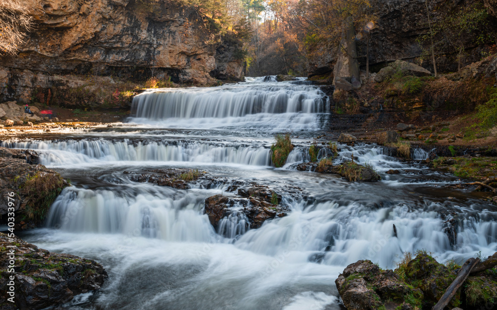 Fototapeta premium Waterfall at Willow River State Park in Hudson Wisconsin in fall