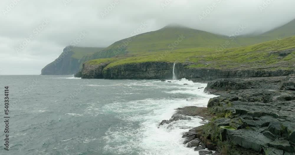 Aerial Panning Scenic View Of Waterfall On Island, Drone Flying Over Wet Landscape - Faroe Islands, Denmark Aerial Panning Scenic View Of Waterfall On Island, Drone Flying Over Wet Landscape - Faroe Islands, Denmark