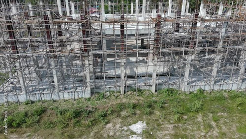 aerial view of building under construction shows the structure of concrete columns and decks and steel frames.