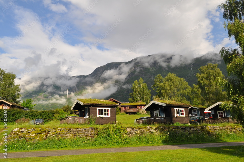 Wooden houses with grass on the roof. Typical Norwegian village houses in the countryside in the mountains.