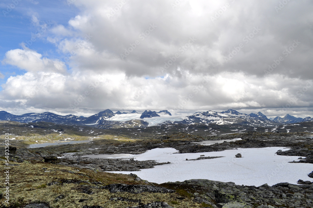 Sognefjell, Jotunheim, Norway - rocky landscape with snow in a natural park. Snow-covered rocks, mountains and icy lakes.