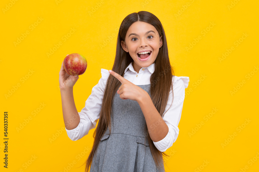 boy eating green apple on yellow isolated background. apples are good for children. Excited face, cheerful emotions of teenager girl. boy eating green apple on yellow isolated background. apples are good for children. Excited face, cheerful emotions of teenager girl.