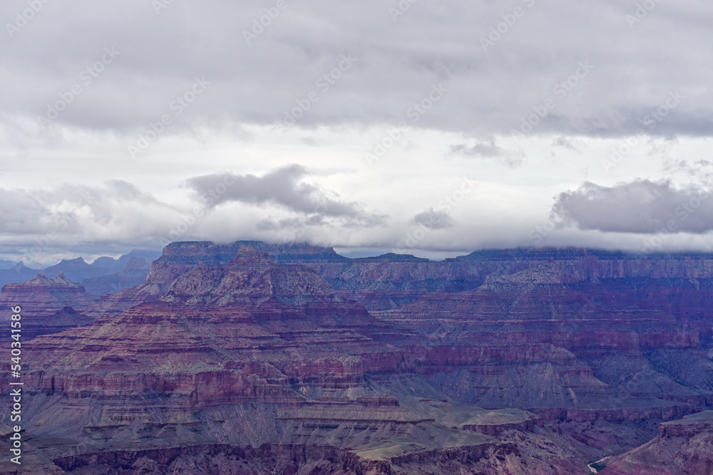 Grand Canyon National Park, Arizona: The muted purple, red, and brown colors of the Grand Canyon under a low cloud cover, seen from the Desert View area of the South Rim.